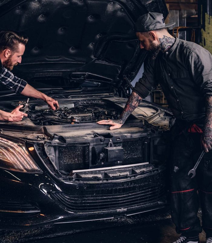 two-bearded-auto-mechanic-working-in-repair-garage-small.jpg
